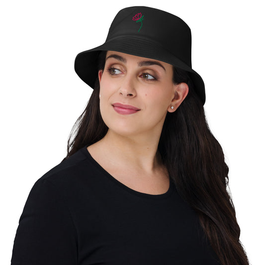 Lady wearing a bucket hat with a flower on the front