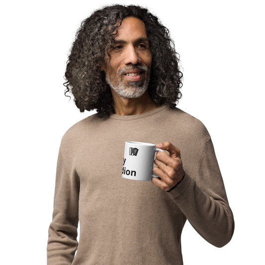 A person holding a white glossy mug with the text 'I Play Accordion' printed on it.