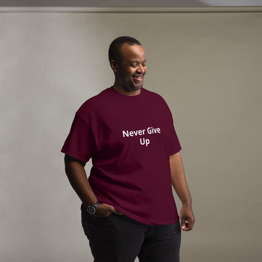 A person wearing a maroon unisex classic t-shirt with the text 'Never Give Up' on the front.